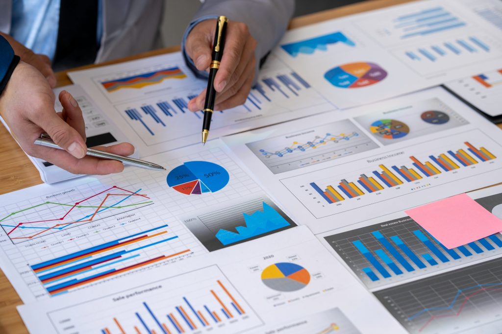 Analyzing results, business people are meeting to analyze data for the marketing plan. Concept of fi