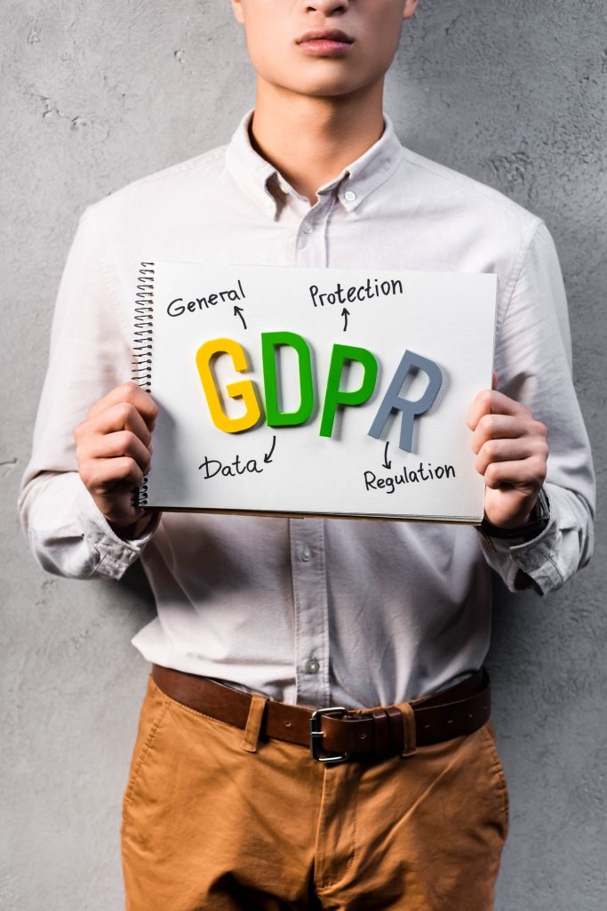 cropped view of businessman holding paper with gdpr lettering