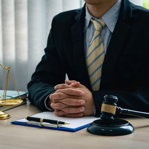 A lawyer or judge is listening to a legal testimony from a client in the lawyer's office. legal advi
