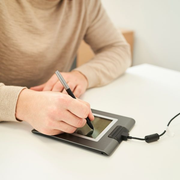 a man signing on a digital tablet