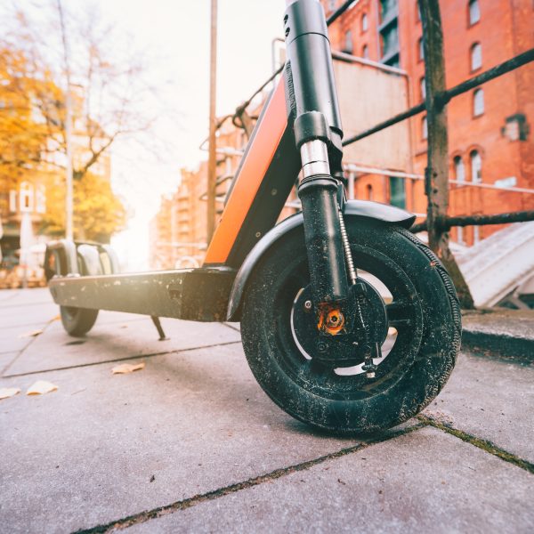 Close up of Electric kick scooter or e-scooter parked on pavement - e-mobility or micro-mobility
