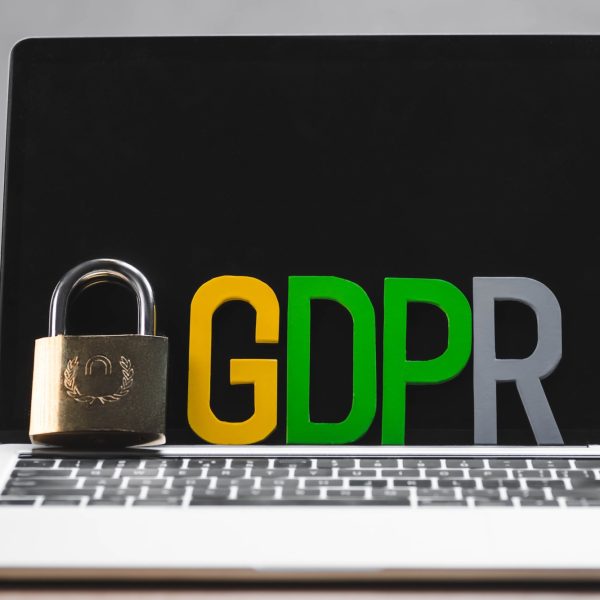 metal padlock and gdpr letters on laptop in office